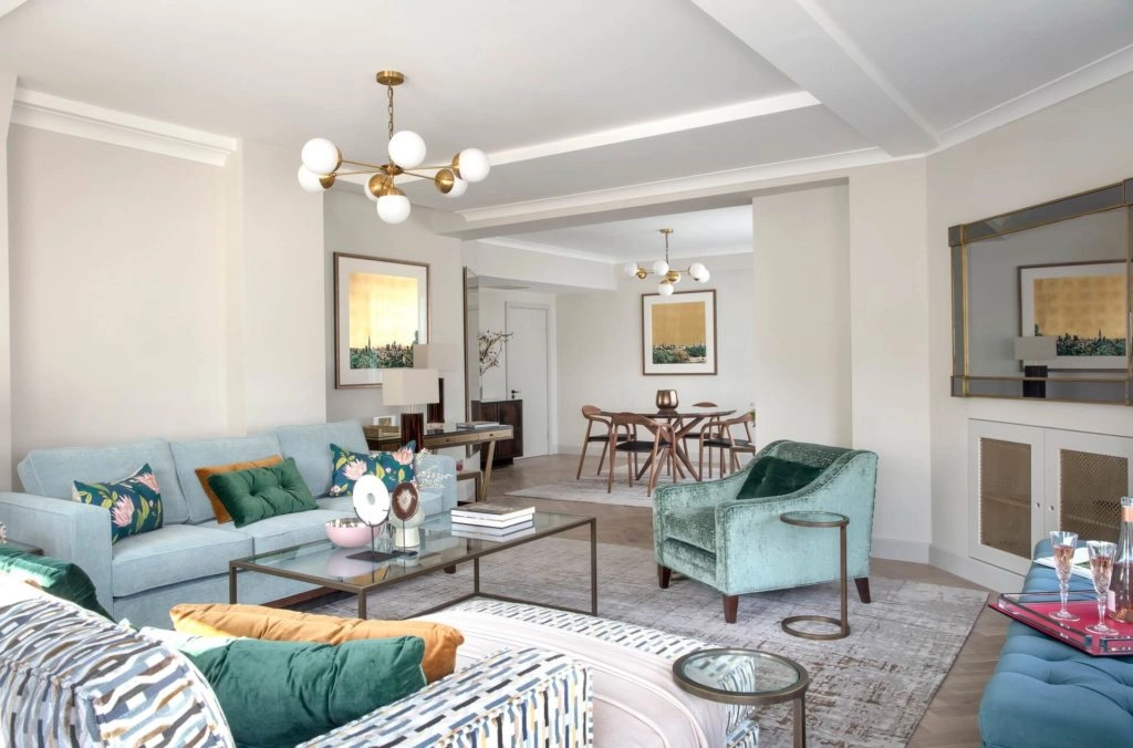 Spacious living area in Arlington House Apartments featuring elegant furnishings, plush seating, and chic decor for a relaxing stay.