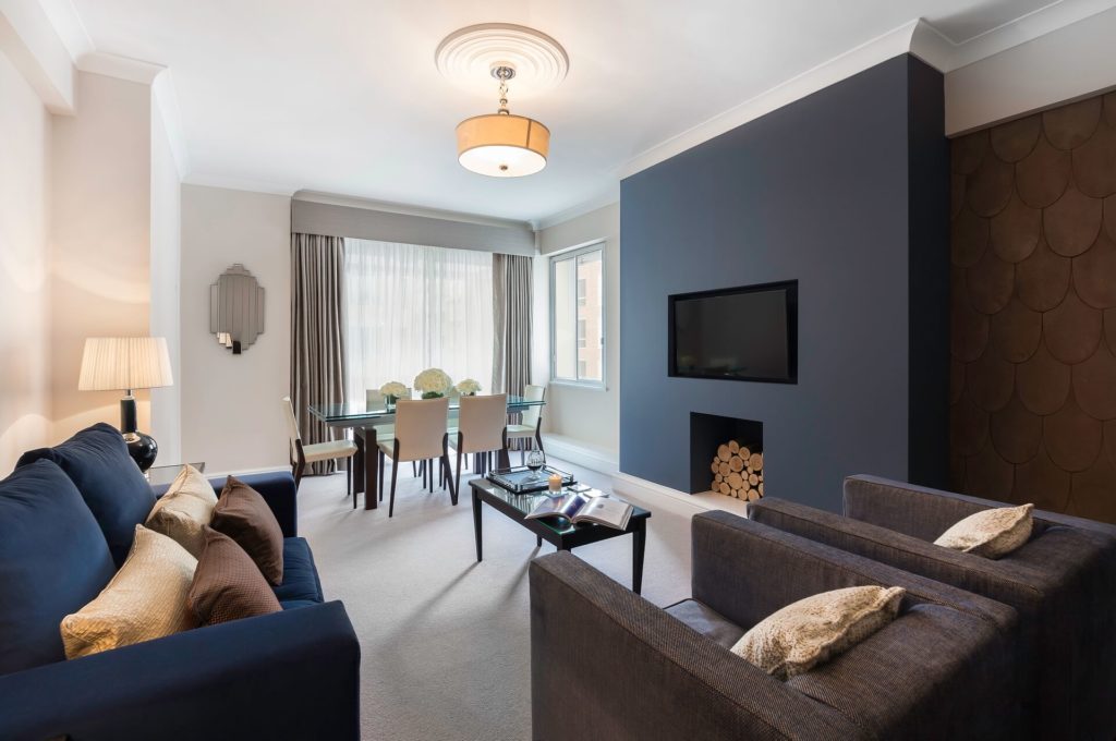 Stylish Arlington House apartment with cosy seating, dining table, modern decor, and large window for bright stay.