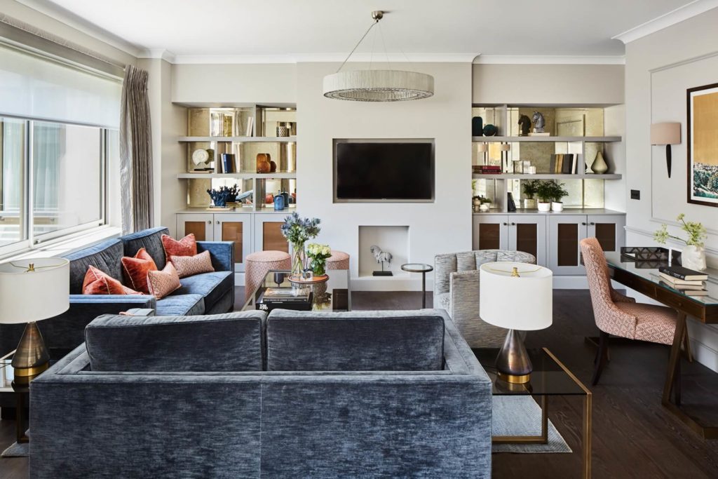 Elegant Arlington House lounge with plush sofas, stylish decor, large TV, and natural light, perfect for relaxation.