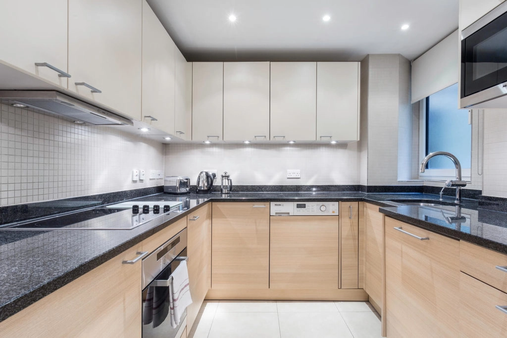 Modern kitchen in Arlington House with sleek worktops, integrated appliances, and ample storage for a homely stay.