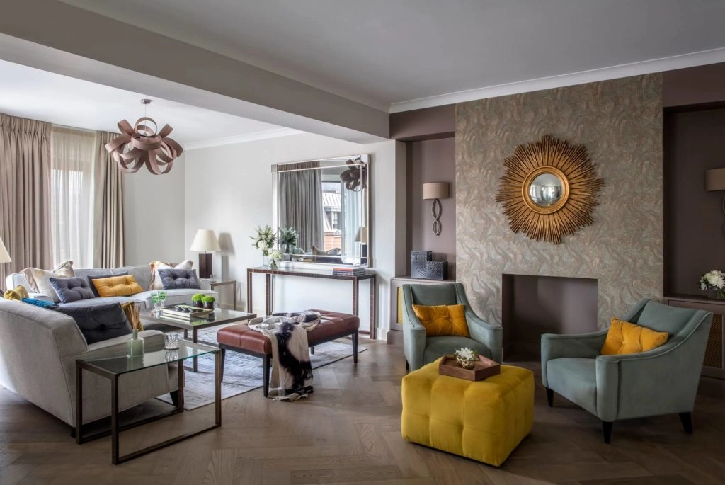 Elegant living room with plush sofas, modern decor, vibrant cushions, and natural light at Arlington House Apartments.