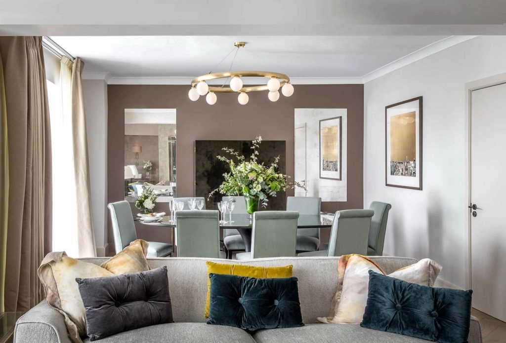 Elegant dining area in Arlington House Apartments with plush seating, chic decor, and inviting atmosphere for guests.