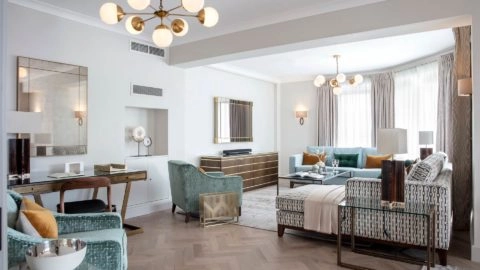 Spacious lounge with elegant decor, plush sofas, modern lighting, and large windows in Arlington House Apartments.